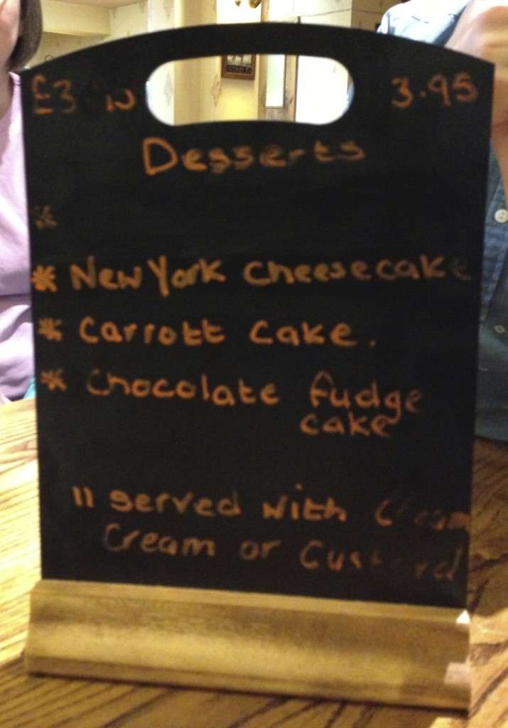 Sign is a menu which advertises carrott cake